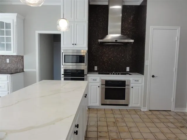 a stove top oven sitting inside of a kitchen