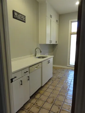 a bathroom with a sink mirror and a toilet