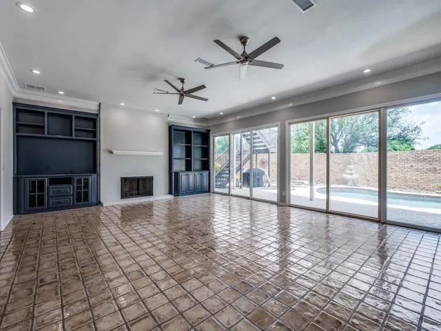 a view of empty room with wooden floor and fireplace