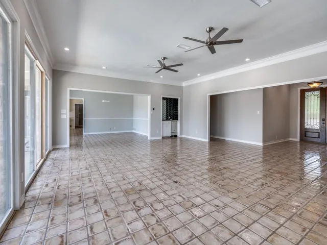 a view of a hallway with a dining table & chairs