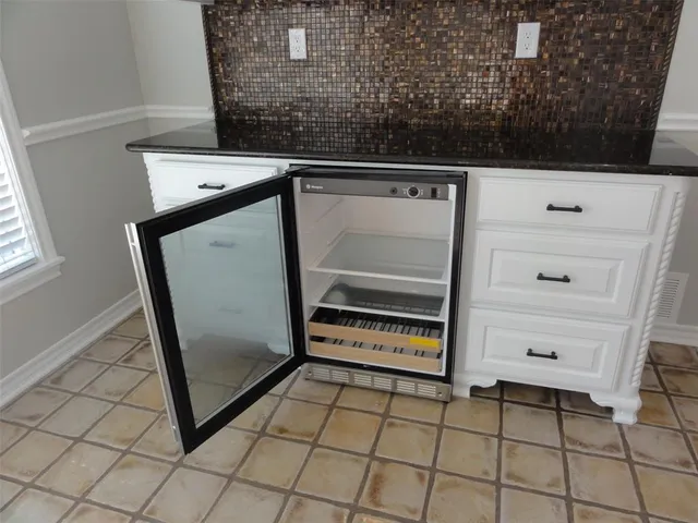 a large kitchen with kitchen island a sink stainless steel appliances and cabinets