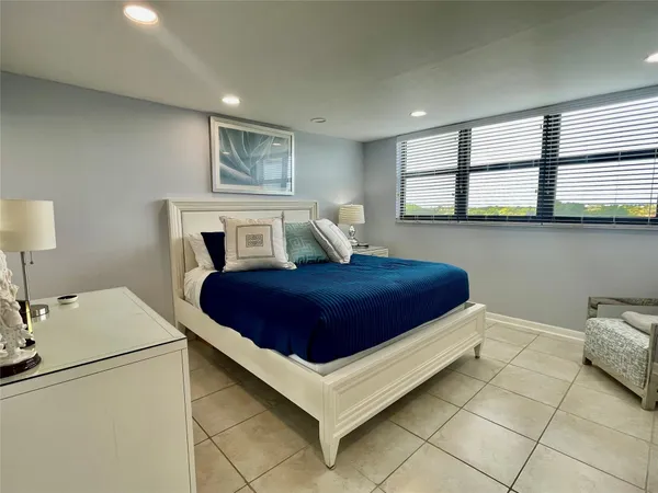 a bedroom with a bed and a view of kitchen