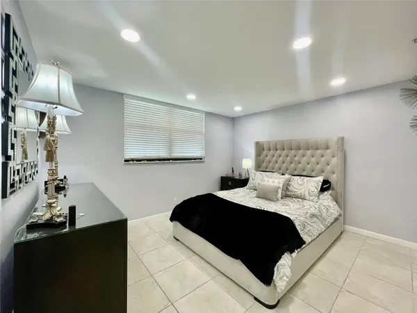 a bedroom with a bed and a lamp
