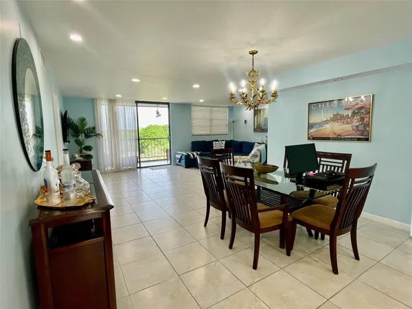 a view of a dining room with furniture and chandelier
