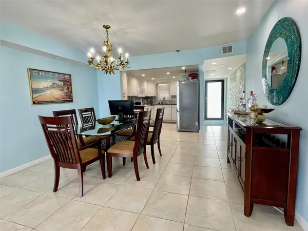 a view of a dining room with furniture and a chandelier