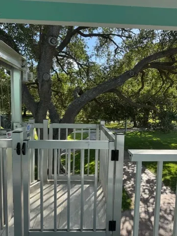 a front view of a house with glass windows and garden