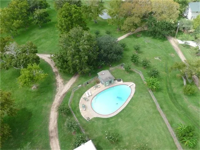 a view of a swimming pool with a yard