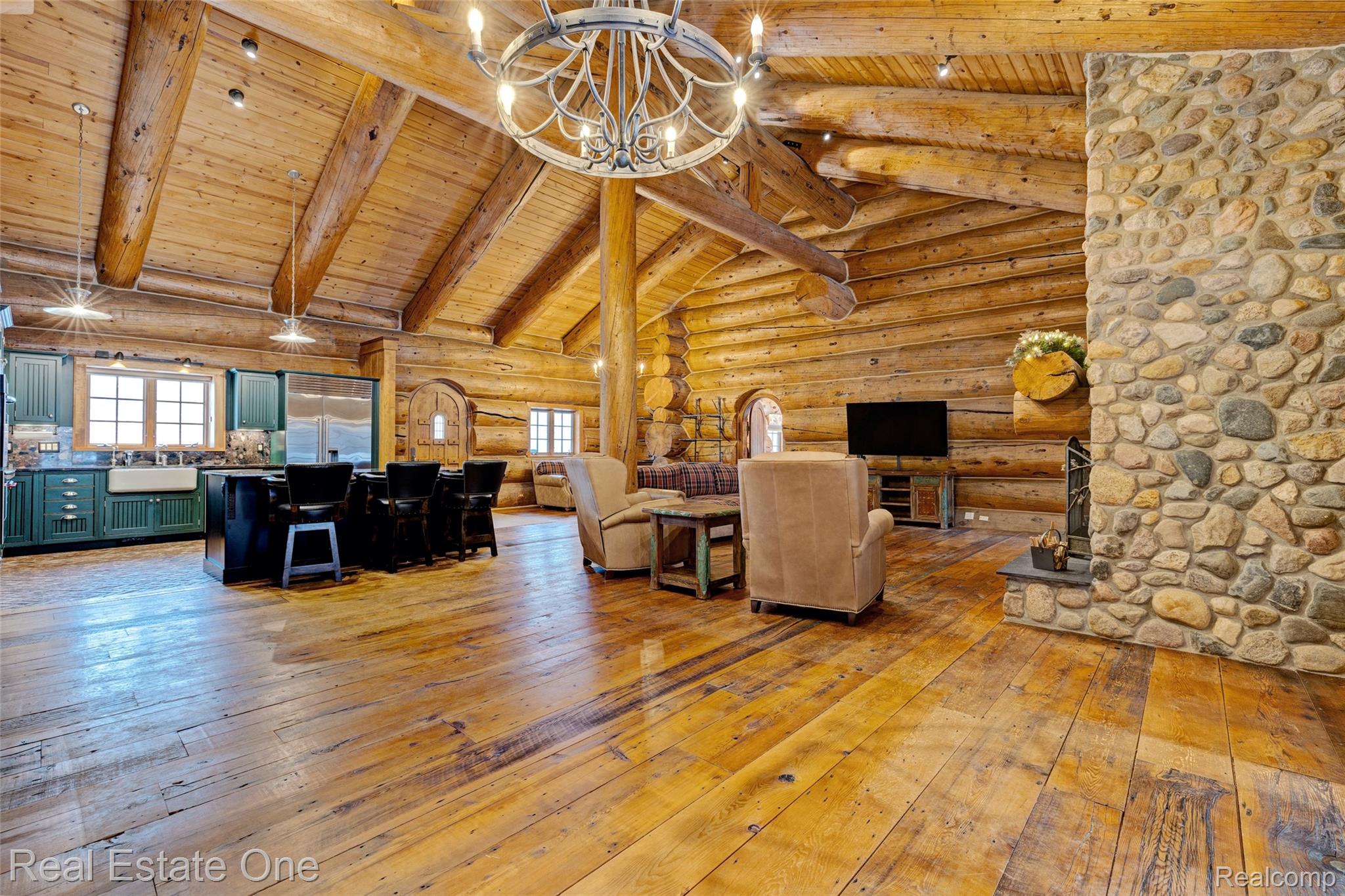 4340 Lahring Road Holly, MI 48442 - Photo 11 of 89 Living area featuring rustic walls, light wood-style flooring, a wood ceiling with exposed beams, high vaulted ceiling, and a chandelier