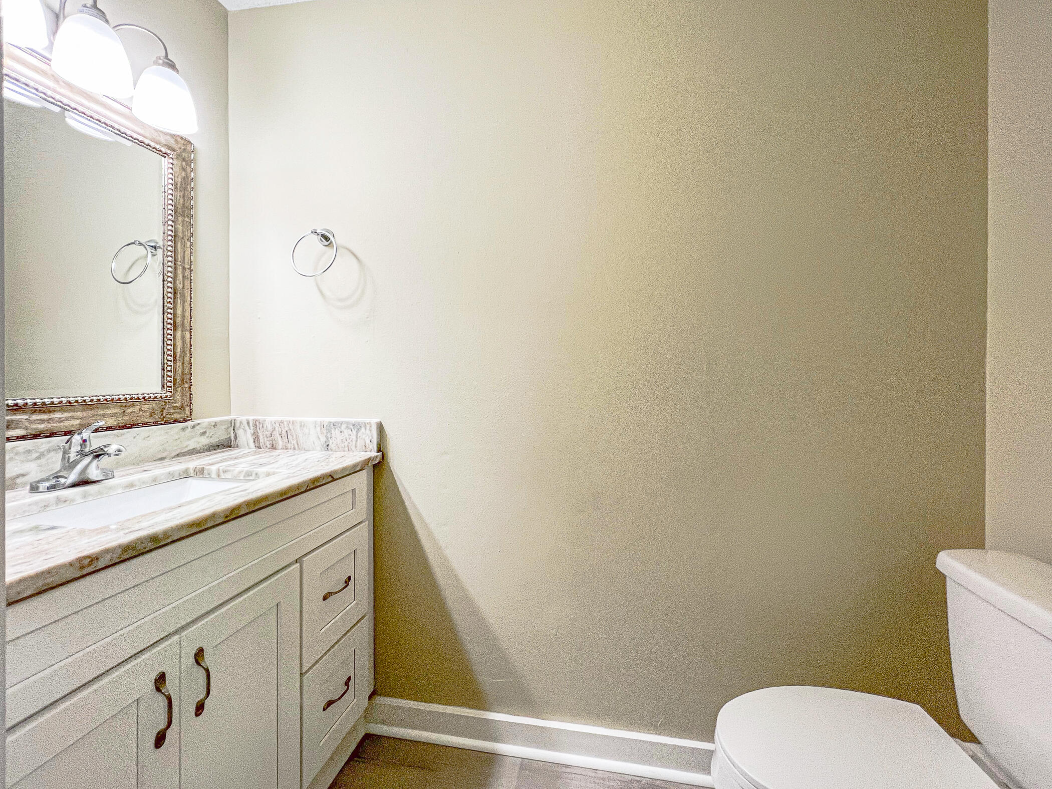 16 Court Drive Destin, FL 32541 - Photo 26 of 50 a bathroom with a granite countertop toilet sink and mirror