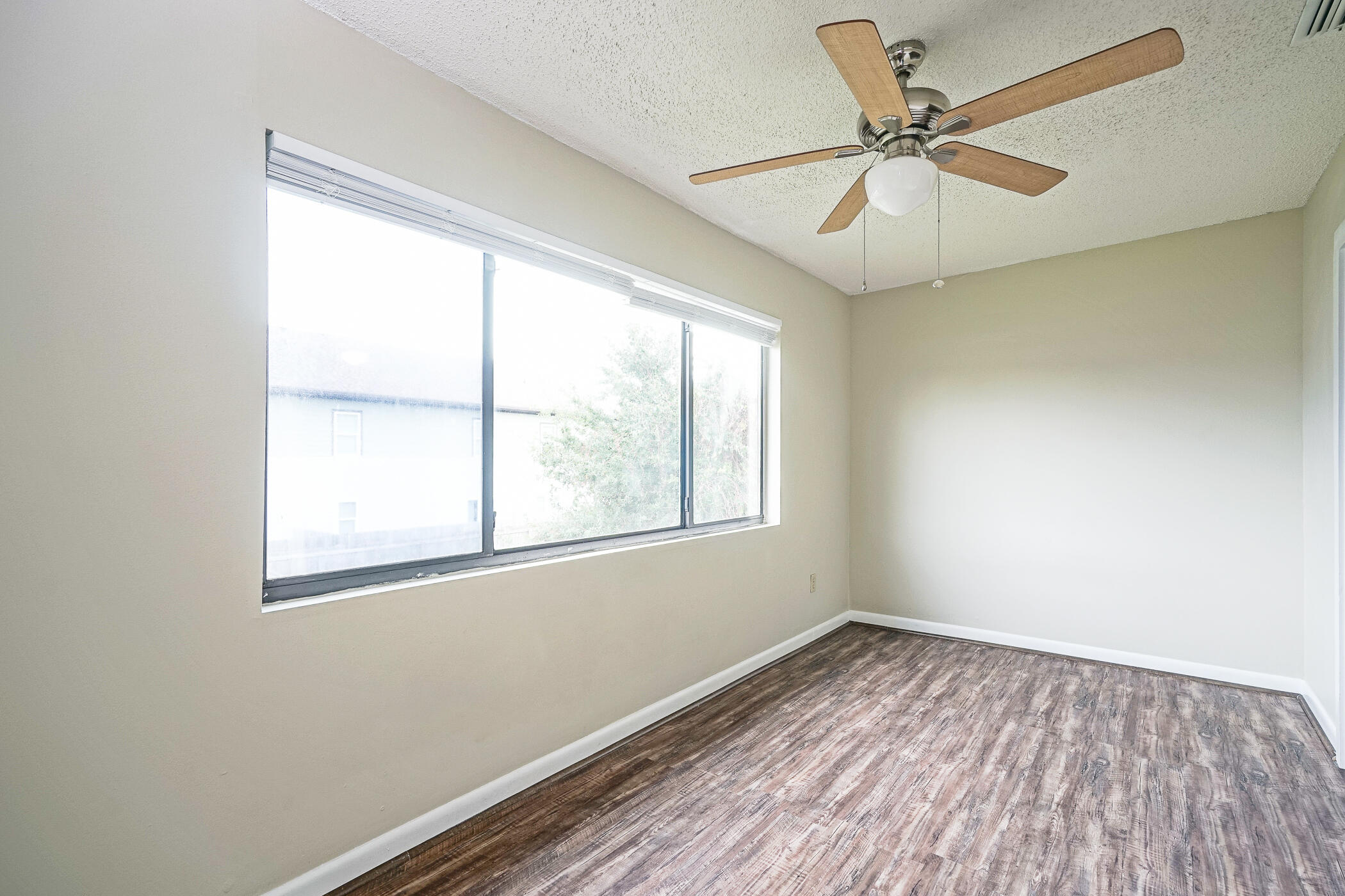 16 Court Drive Destin, FL 32541 - Photo 28 of 50 a view of empty room with wooden floor and fan