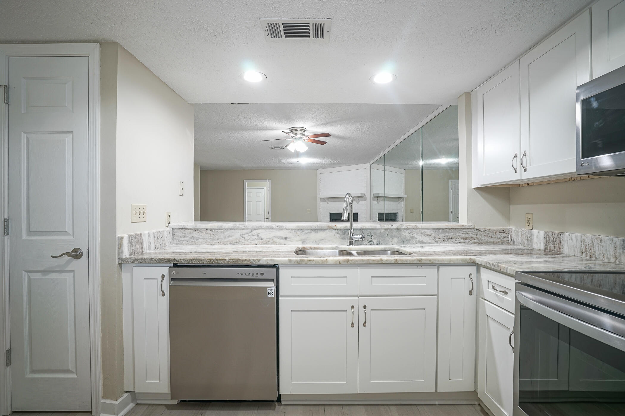 16 Court Drive Destin, FL 32541 - Photo 6 of 50 a kitchen with a sink stove and cabinets