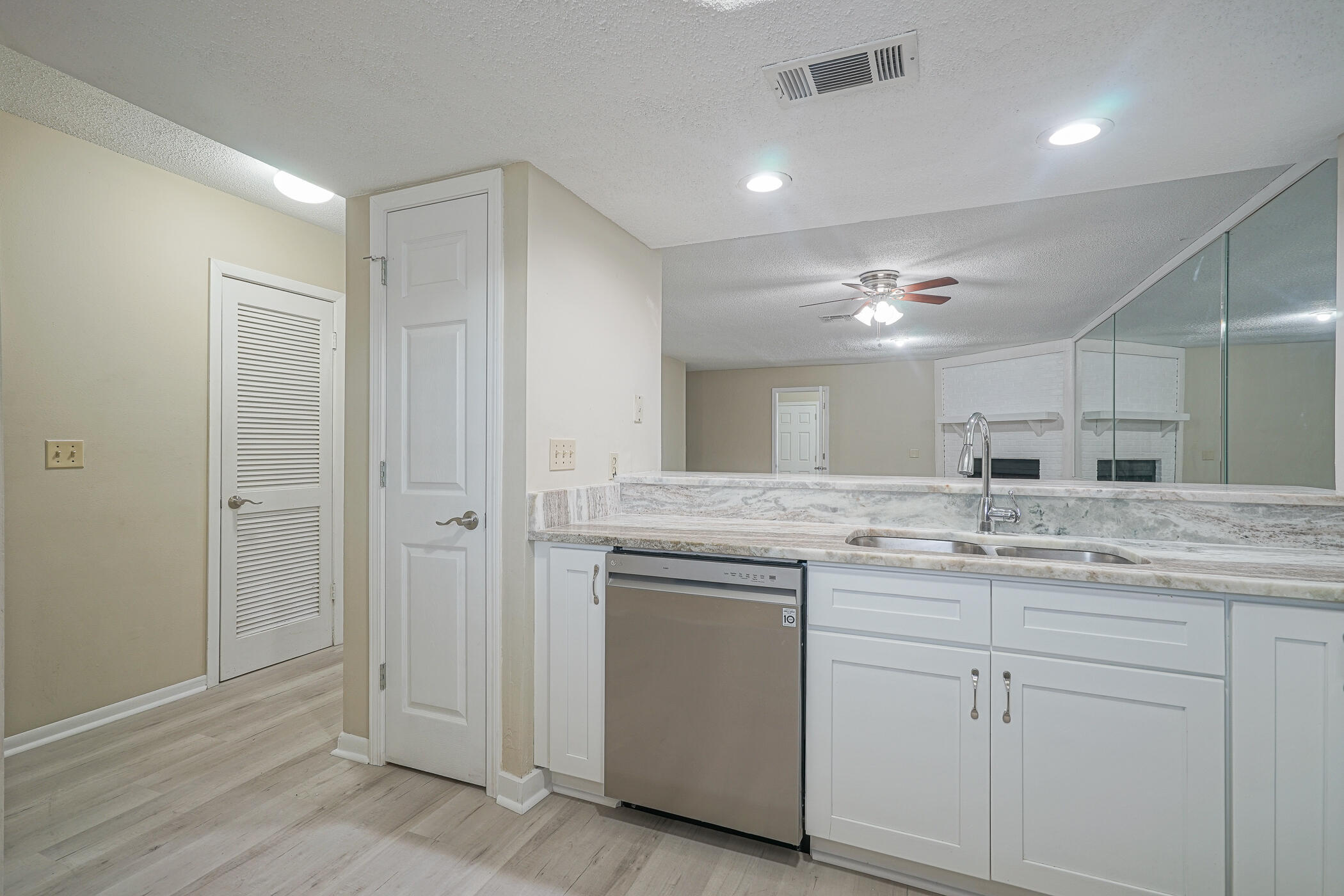 16 Court Drive Destin, FL 32541 - Photo 7 of 50 a bathroom with a granite countertop sink and a mirror