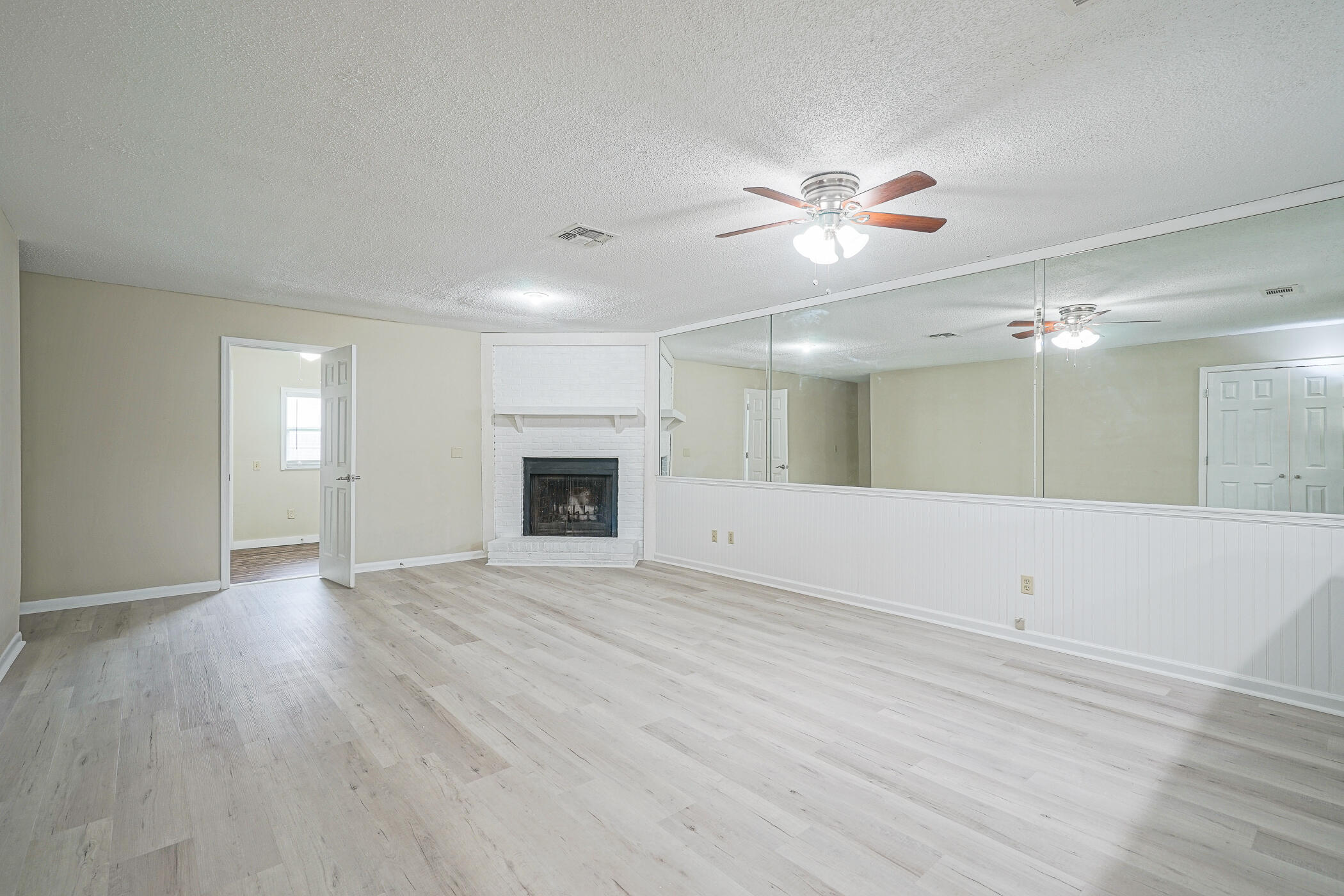 16 Court Drive Destin, FL 32541 - Photo 8 of 50 a view of an empty room with window and wooden floor