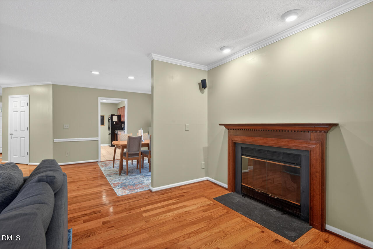 3307 Coachman's Way Durham, NC 27705 - Photo 19 of 50 a living room with furniture a fireplace and a table