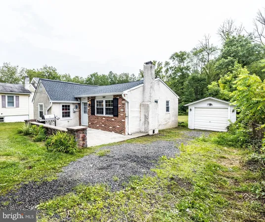a view of a house with a backyard and trees