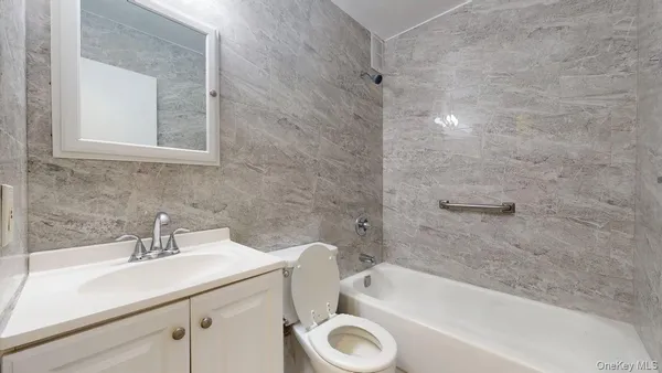 a bathroom with a sink a toilet and bathtub