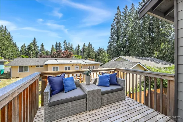 a view of a roof deck with furniture