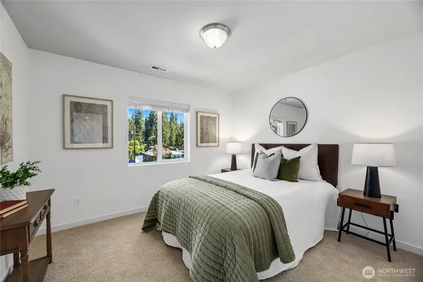 a bedroom with a bed and a potted plant