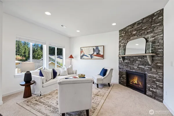 a living room with furniture a fireplace and a flat screen tv