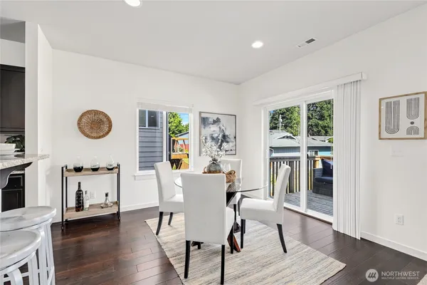a view of a dining room with furniture and wooden floor