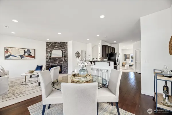 a view of a dining room with furniture a kitchen and chandelier