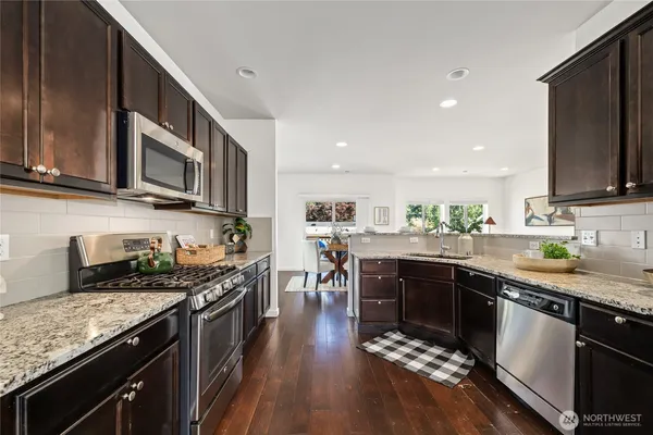 a kitchen with stainless steel appliances granite countertop counter space a sink and cabinets