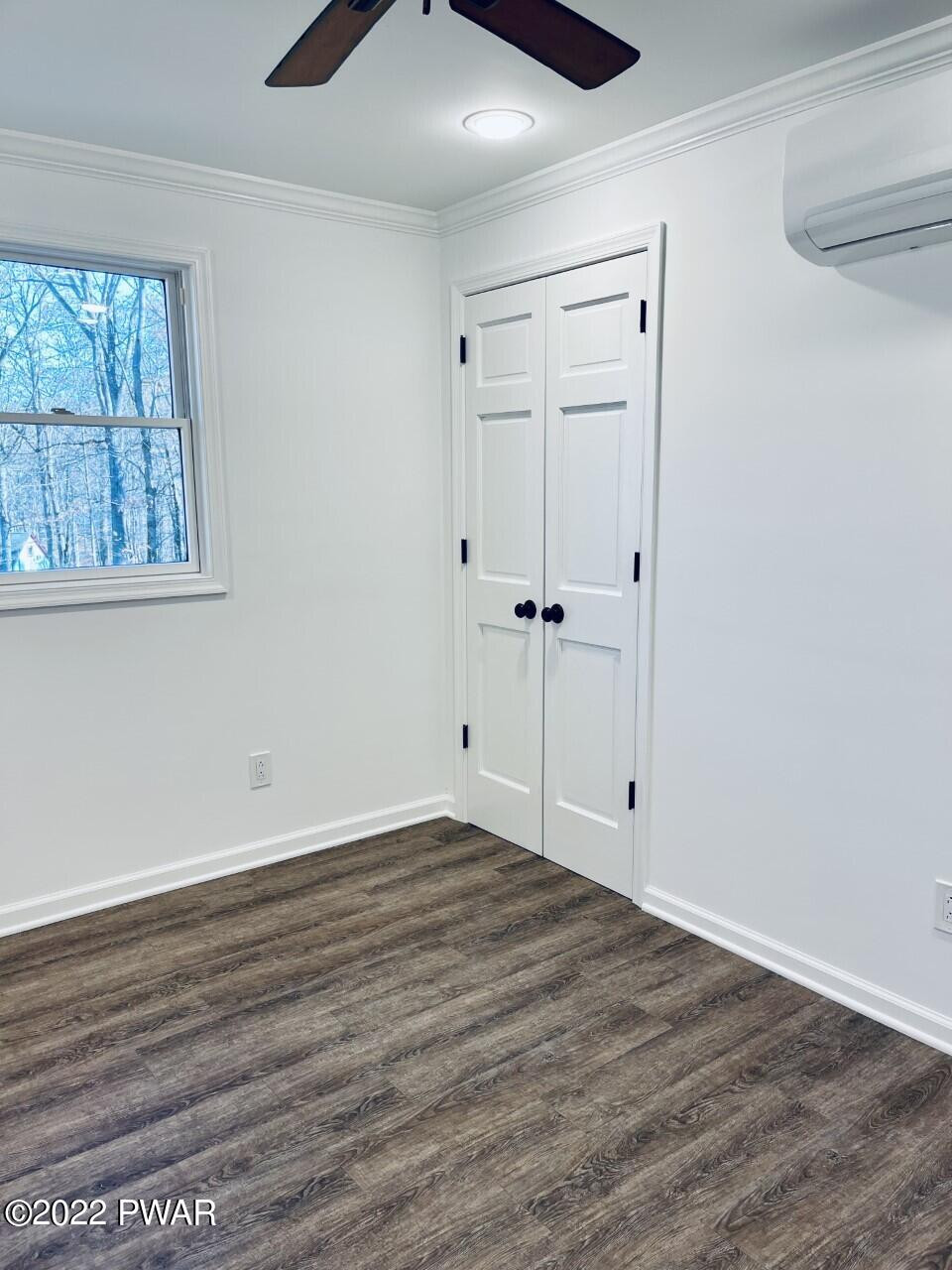 197 Gold Key Road Milford, PA 18337 - Photo 15 of 34 a view of an empty room with wooden floor and a window