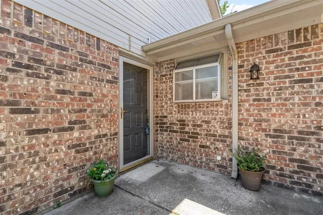 a view of front door of house with potted plant