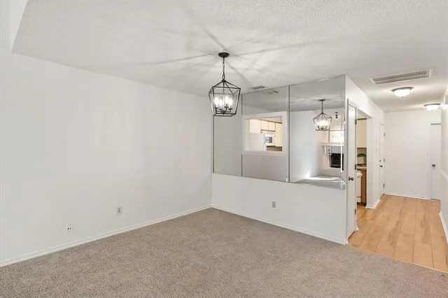 a view of a kitchen with a refrigerator cabinets and a wooden floor