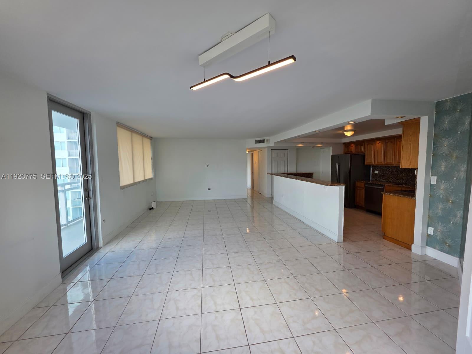 7135 Collins Avenue, Unit 725 Miami Beach, FL 33141 - Photo 1 of 21 a view of a hallway with kitchen and entryway