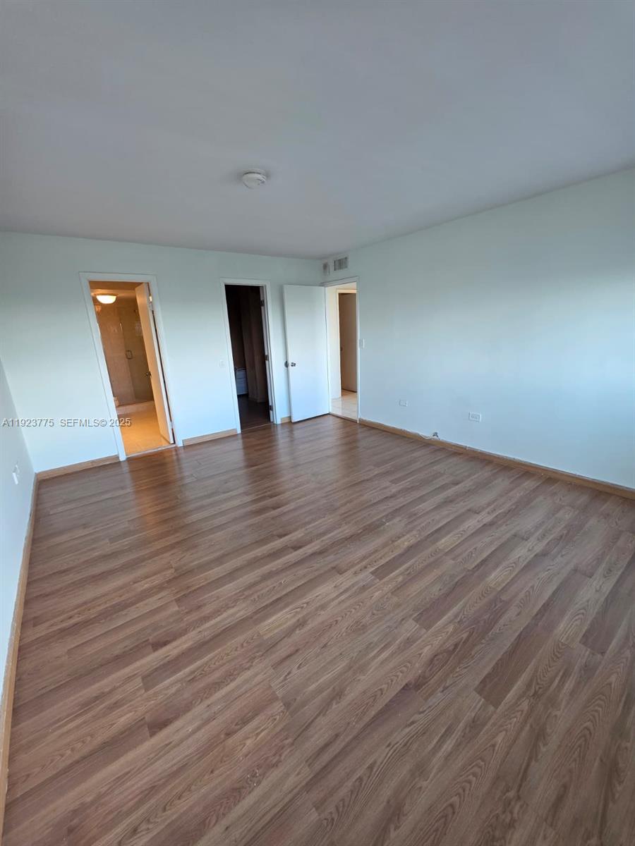 7135 Collins Avenue, Unit 725 Miami Beach, FL 33141 - Photo 14 of 21 a view of empty room with wooden floor