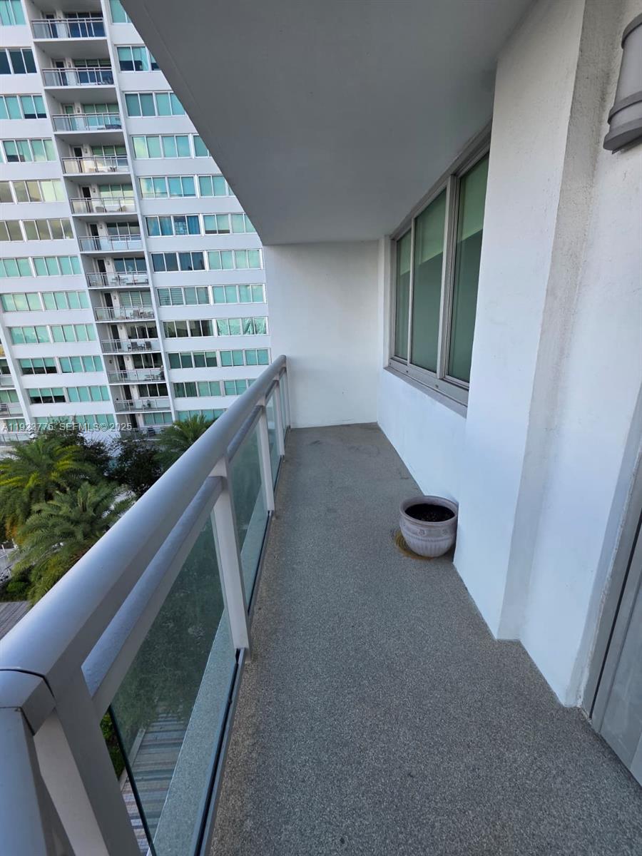 7135 Collins Avenue, Unit 725 Miami Beach, FL 33141 - Photo 19 of 21 a view of balcony with wooden floor and seating