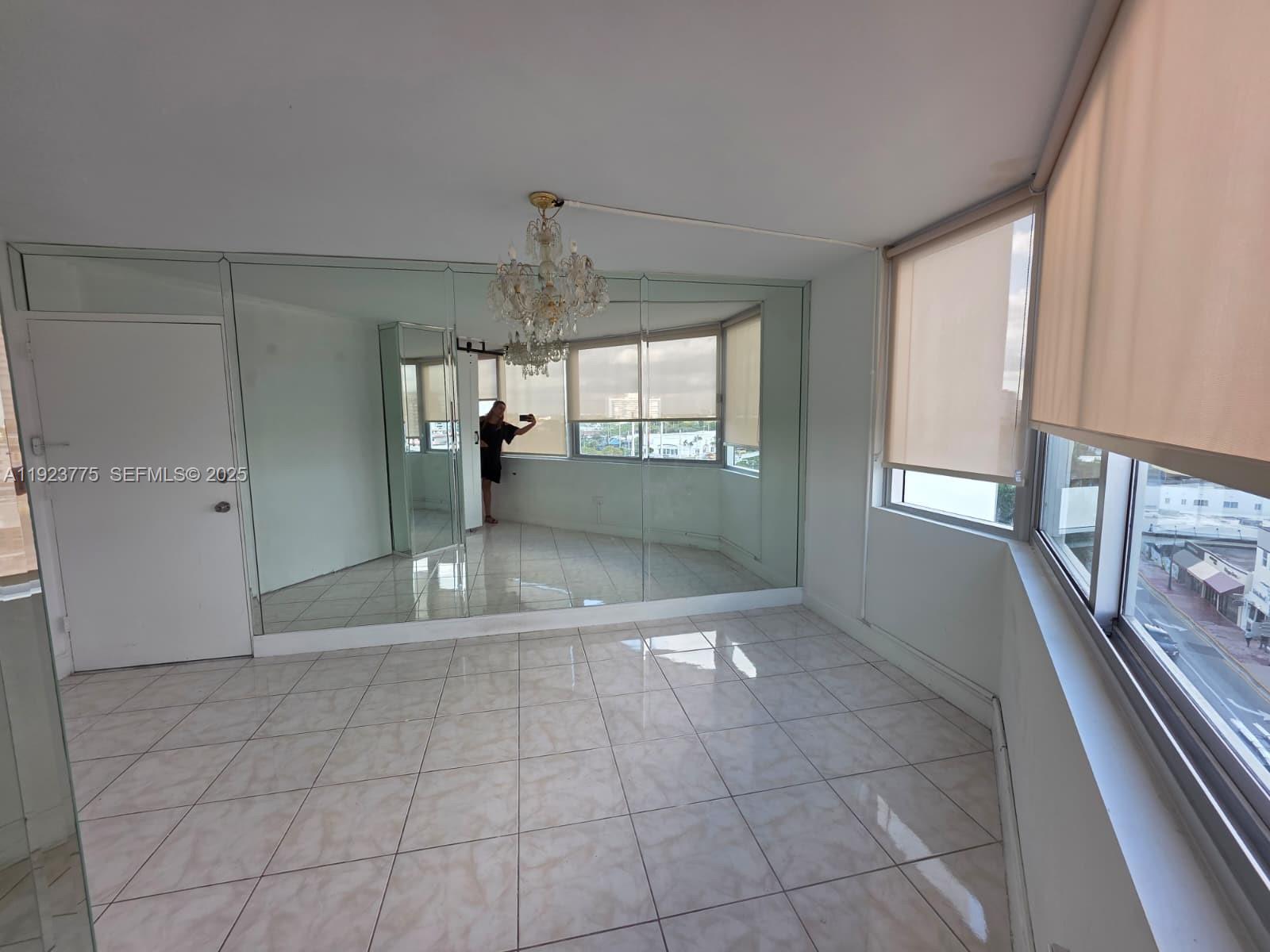 7135 Collins Avenue, Unit 725 Miami Beach, FL 33141 - Photo 3 of 21 a view of an empty room and window