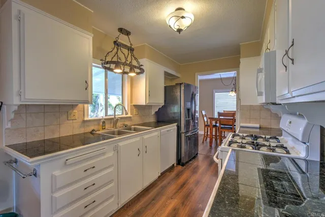 a kitchen with a sink stove and cabinets