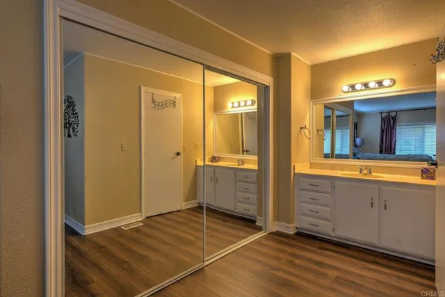 a view of a bathroom with double vanity and a mirror