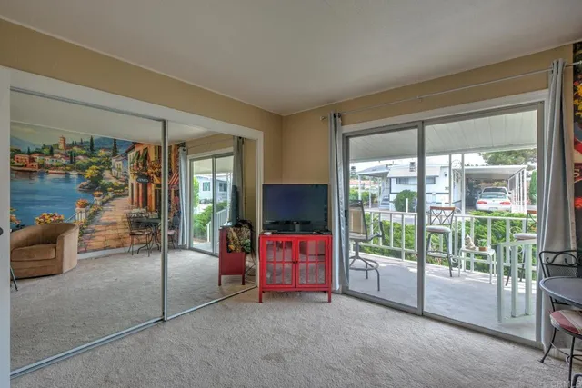 a living room with furniture and a floor to ceiling window