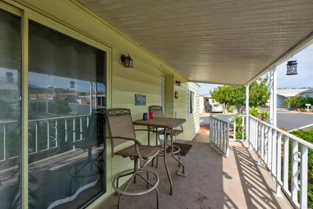 a view of a chairs and table in the balcony