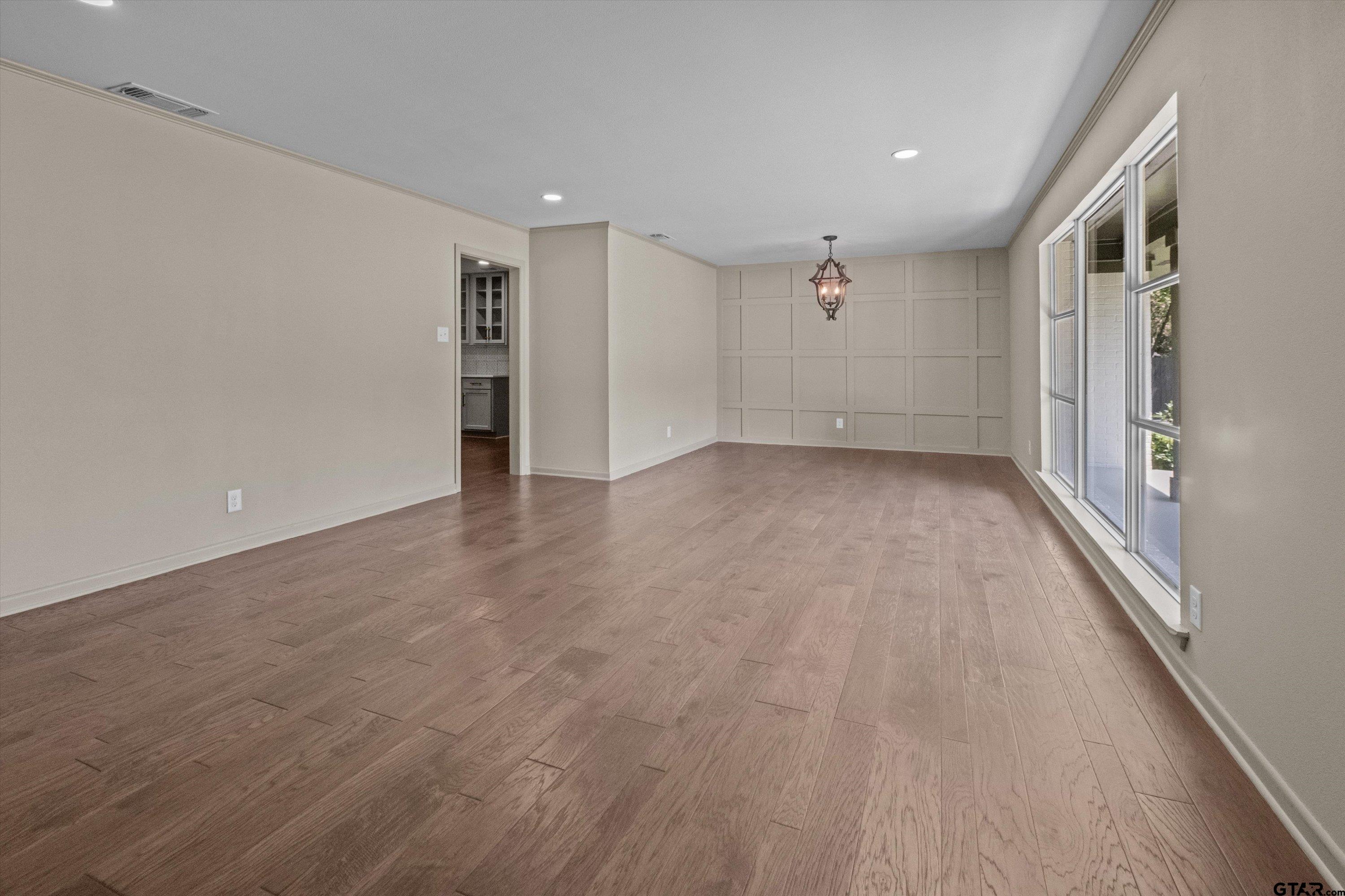 2515 Preston Avenue Tyler, TX 75701 - Photo 20 of 27 a view of an empty room with wooden floor and windows