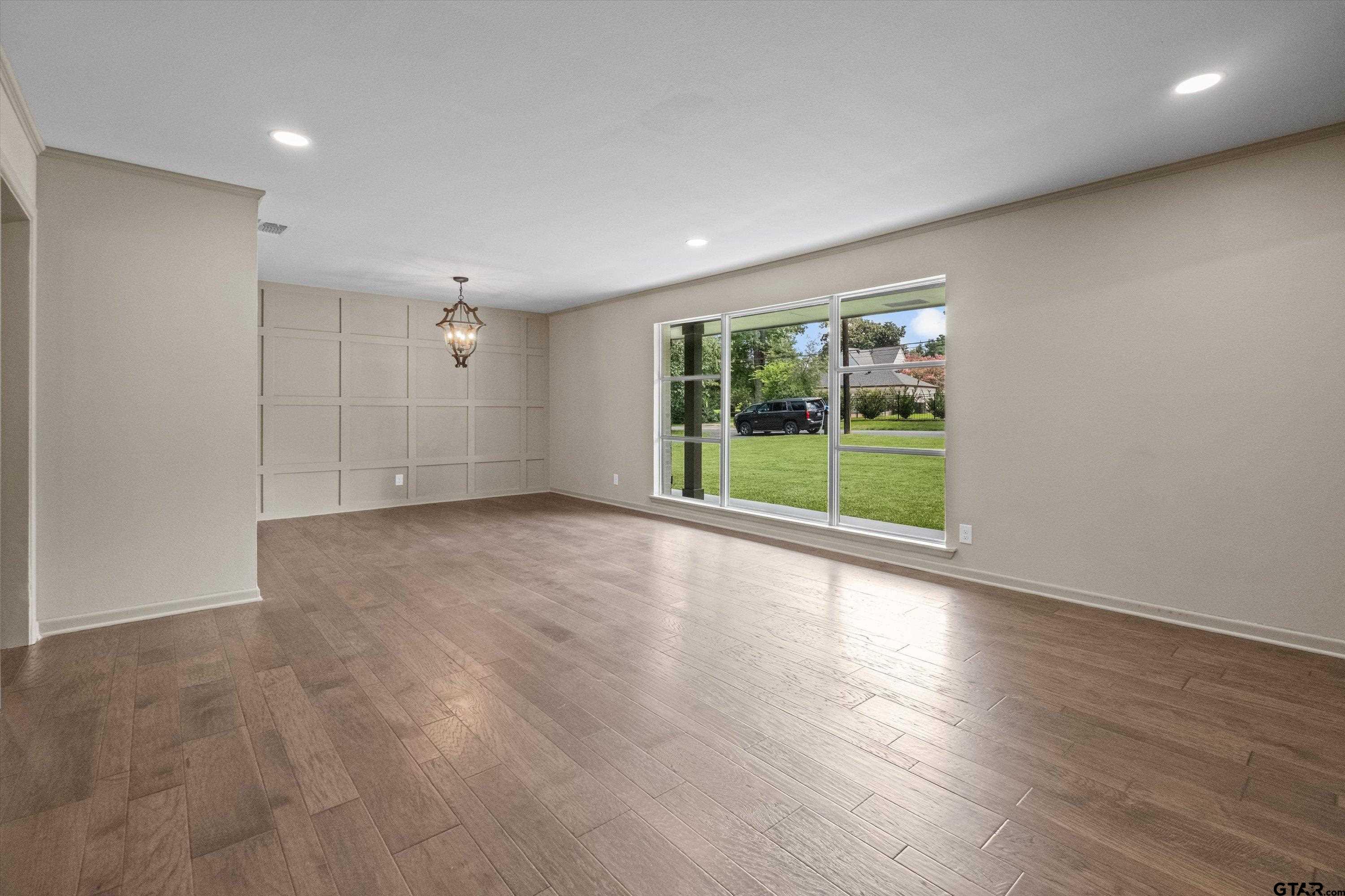 2515 Preston Avenue Tyler, TX 75701 - Photo 4 of 27 an empty room with wooden floor and windows