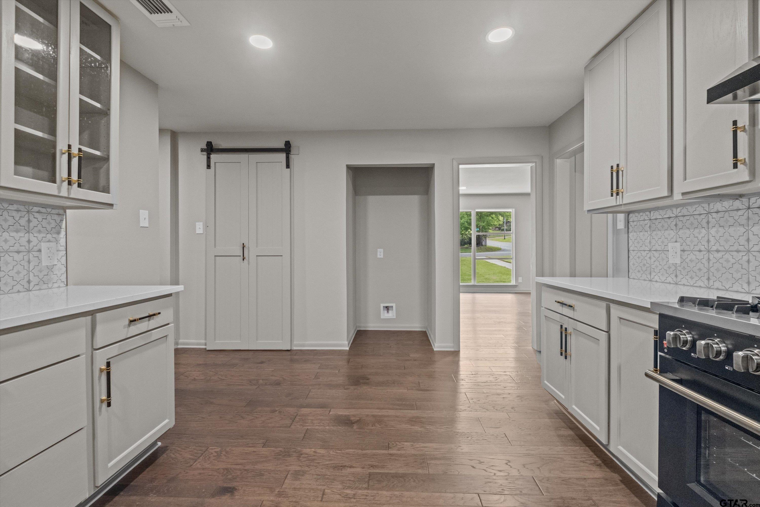 2515 Preston Avenue Tyler, TX 75701 - Photo 7 of 27 a kitchen with granite countertop a stove and cabinets