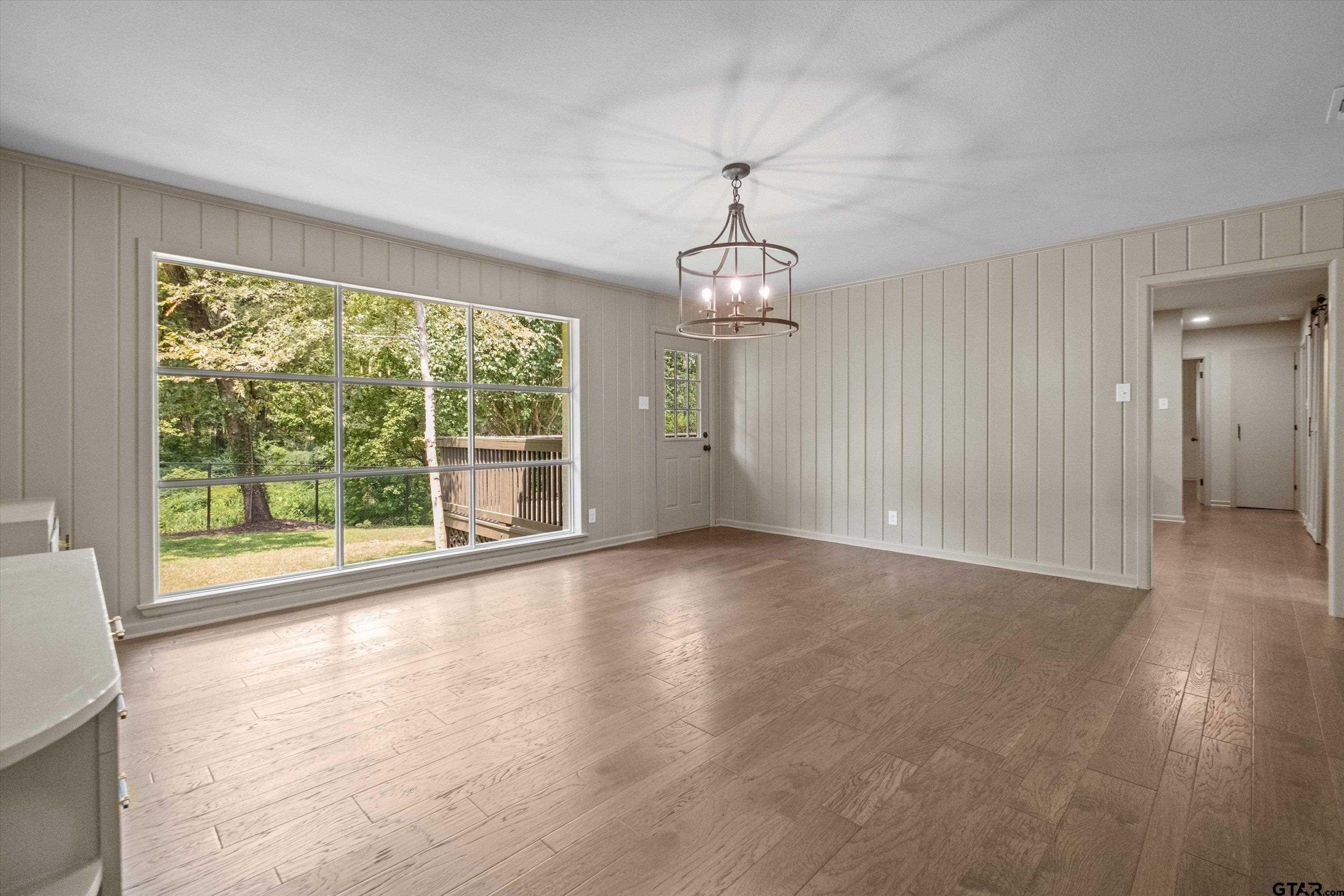 2515 Preston Avenue Tyler, TX 75701 - Photo 9 of 27 a view of an empty room with wooden floor and a window