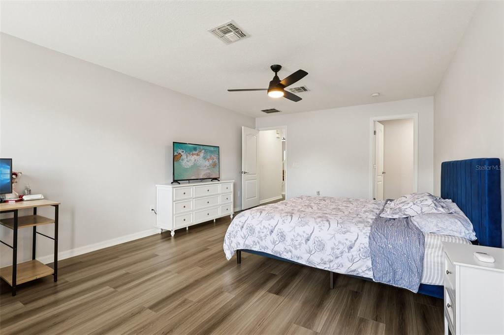 2104 Congress Lane St. Cloud, FL 34769 - Photo 18 of 71 a bedroom with a bed and a flat screen tv