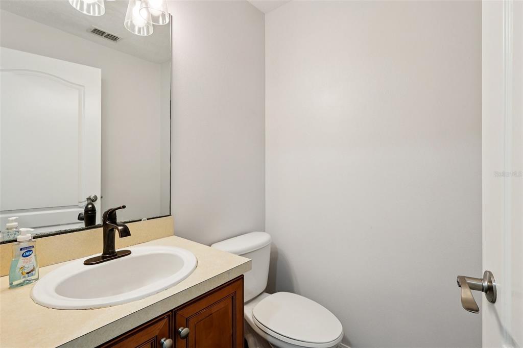 2104 Congress Lane St. Cloud, FL 34769 - Photo 26 of 71 a bathroom with a sink and a toilet