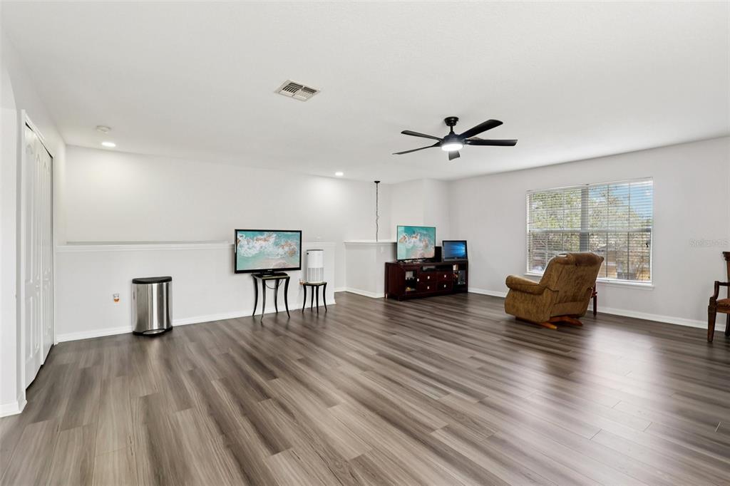 2104 Congress Lane St. Cloud, FL 34769 - Photo 27 of 71 a living room with furniture and a wooden floor