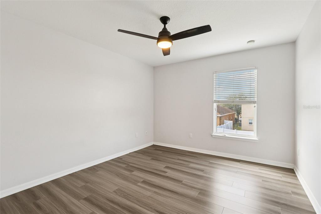 2104 Congress Lane St. Cloud, FL 34769 - Photo 31 of 71 an empty room with wooden floor and windows