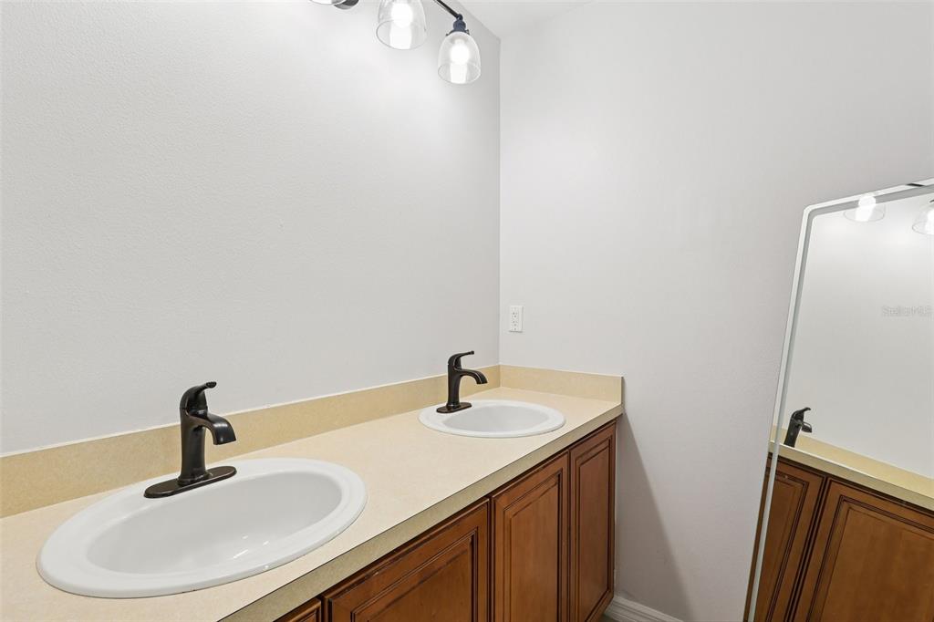 2104 Congress Lane St. Cloud, FL 34769 - Photo 34 of 71 a bathroom with a sink and a mirror