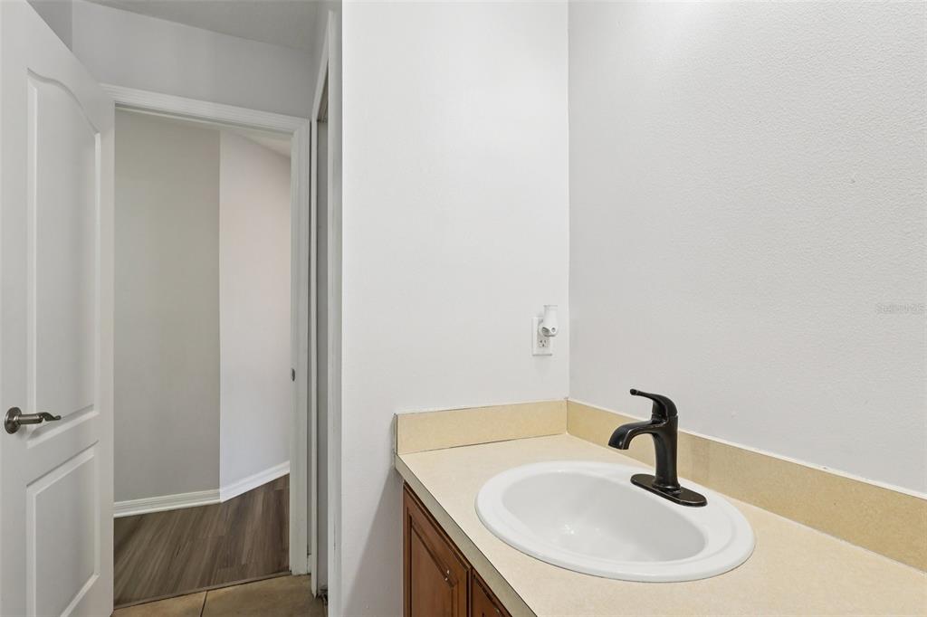 2104 Congress Lane St. Cloud, FL 34769 - Photo 35 of 71 a bathroom with a sink and a mirror