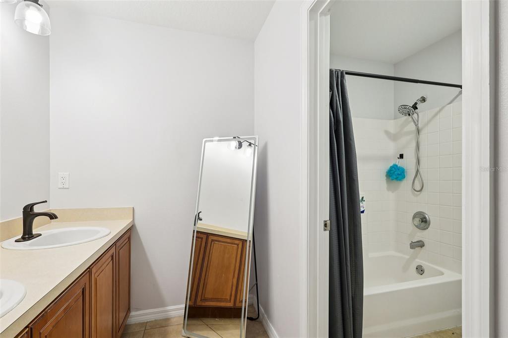 2104 Congress Lane St. Cloud, FL 34769 - Photo 36 of 71 a bathroom with a shower and a sink
