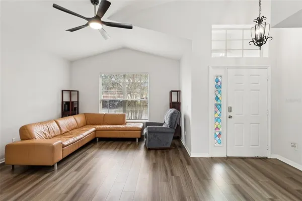 a living room with furniture and a chandelier