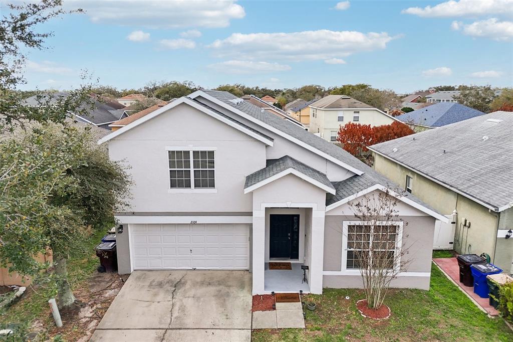 2104 Congress Lane St. Cloud, FL 34769 - Photo 43 of 71 front view of a house with a yard
